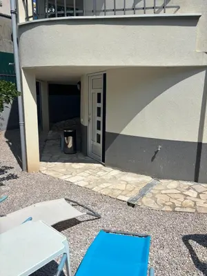 a blue chair sitting in front of a building at studio Oliva home in Utjeha