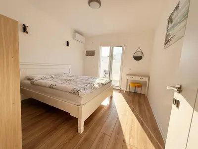 a bedroom with a bed and a wooden floor at Donji Stoj Rene Villa in Donji Štoj
