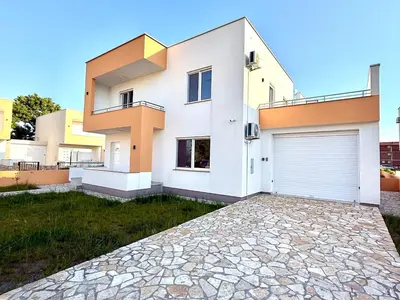 a large white house with a garage at Donji Stoj Rene Villa in Donji Štoj