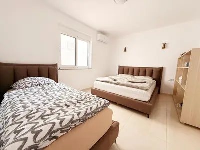 a bedroom with two beds and a window at Donji Stoj Rene Villa in Donji Štoj