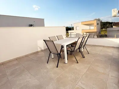 a white table and chairs on a balcony at Donji Stoj Rene Villa in Donji Štoj