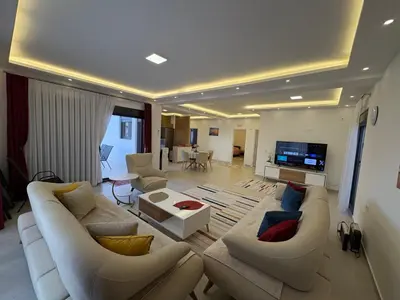 a living room with white couches and a tv at Luxury Villa Ulcinj Štoj in Donji Štoj