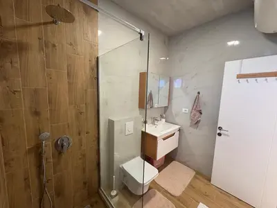 a bathroom with a shower and a toilet and a sink at Luxury Villa Ulcinj Štoj in Donji Štoj