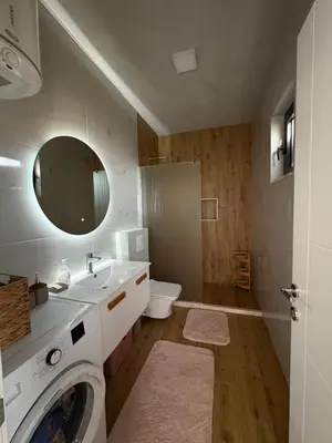a bathroom with a sink and a washing machine at Luxury Villa Ulcinj Štoj in Donji Štoj