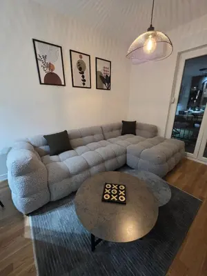 a living room with a couch and a table at Apartman AS in Podgorica