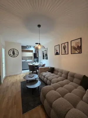 a living room with a couch and a table at Apartman AS in Podgorica