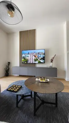 a living room with a coffee table and a flat screen tv at Apartman AS in Podgorica