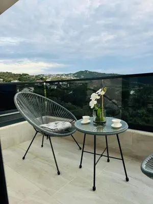 a chair and a table on a balcony with a view at Villa Nova Bar in Bar