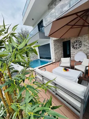 a patio with white furniture and a swimming pool at Villa Nova Bar in Bar