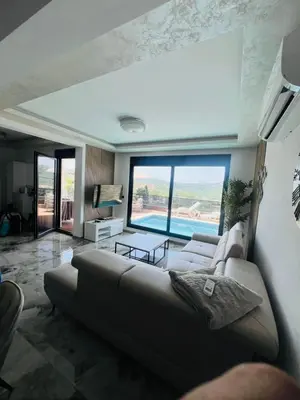 a living room with a couch and a large window at Villa Nova Bar in Bar
