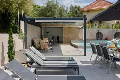 a patio with lounge chairs and a swimming pool at Villa Oaza with Outdoor Pool in Kotor