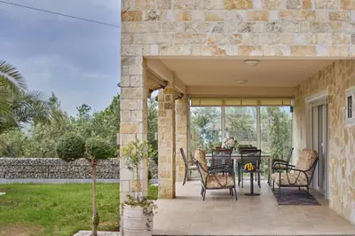 a patio with a table and chairs on it at Villa Oaza with Outdoor Pool in Kotor