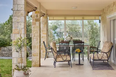 an outdoor patio with a table and chairs at Villa Oaza with Outdoor Pool in Kotor