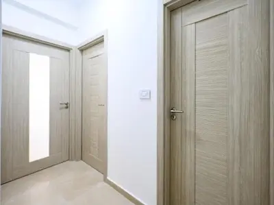 a hallway with two doors in a building at Apartman Adriatico 10 in Bar, Susanj