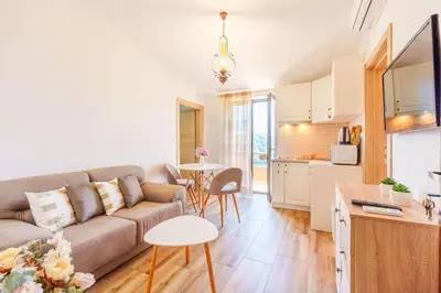 a living room with a couch and a kitchen at Big Hill Apartment 2 in Kotor