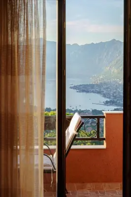 a room with a window with a view of the water at Big Hill Apartment 2 in Kotor
