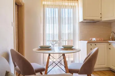 a kitchen with a table with two bowls on it at Big Hill Apartment 2 in Kotor