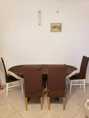a dining room table and chairs in a room at Отдых с комфортом и близко к морю in Bar, Susanj