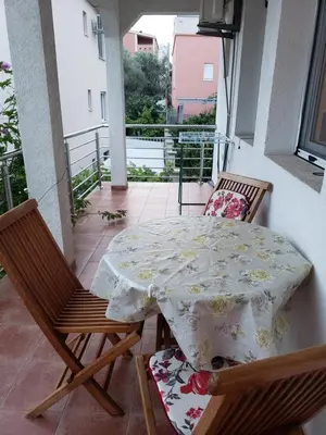 a table and two chairs on a balcony at Отдых с комфортом и близко к морю in Bar, Susanj