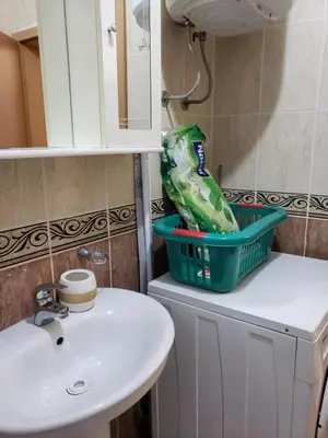 a bathroom with a basket on top of a sink at Отдых с комфортом и близко к морю in Bar, Susanj