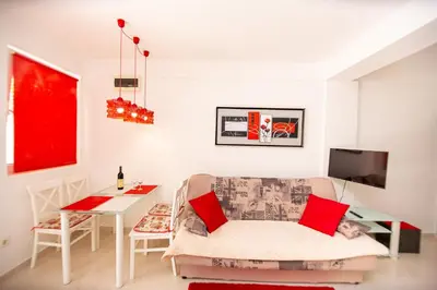 a living room with a couch and a table at KlubNika in Budva