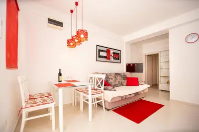 a living room with a couch and a table at KlubNika in Budva