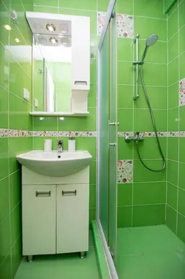 a green bathroom with a sink and a shower at KlubNika in Budva