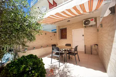 a patio with a table and chairs in a building at KlubNika in Budva