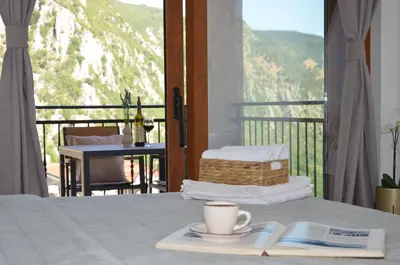 a bed with a book and a cup of coffee on it at Azure Boka in Trojica