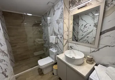 a bathroom with a sink and a toilet and a mirror at Azure Boka in Trojica
