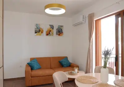 a living room with a couch and a table at Azure Boka in Trojica