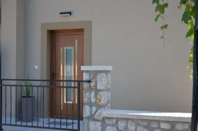 a front door of a house with a black fence at Azure Boka in Trojica