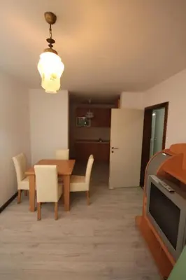 a living room with a dining table and a tv at Lotos in Dobra Voda