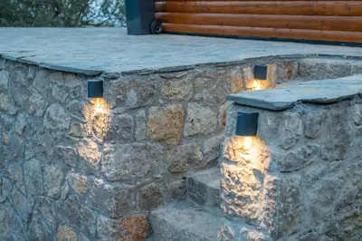 a stone retaining wall with lights on it at Villa Baccarat in Ulcinj