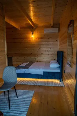 a room with a bed in a wooden cabin at Villa Baccarat in Ulcinj