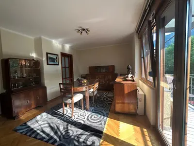 a living room with a table and a dining room at Central Kotor Bay Condo with amazing view in Kotor