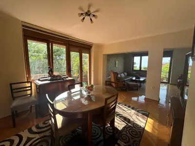 a dining room with a table and chairs and a living room at Central Kotor Bay Condo with amazing view in Kotor