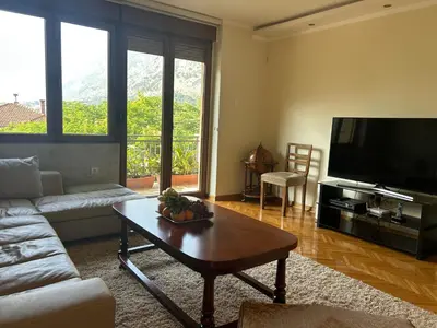 a living room with a couch and a coffee table at Central Kotor Bay Condo with amazing view in Kotor