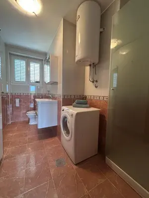 a bathroom with a washing machine and a toilet at Central Kotor Bay Condo with amazing view in Kotor