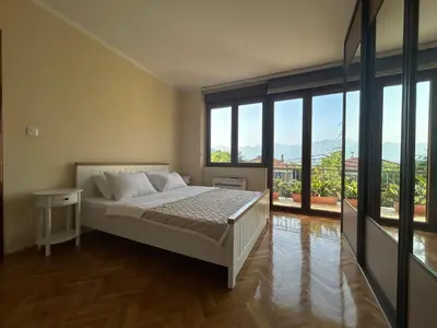 a bedroom with a bed and a large window at Central Kotor Bay Condo with amazing view in Kotor