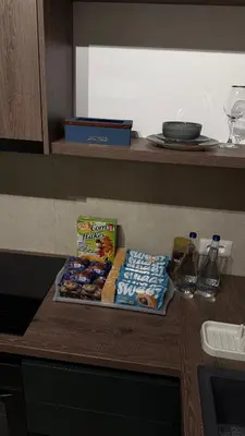 a counter with a tray of snacks on a table at Becici Green Oasis Apartment - Nature & Comfort in Becici