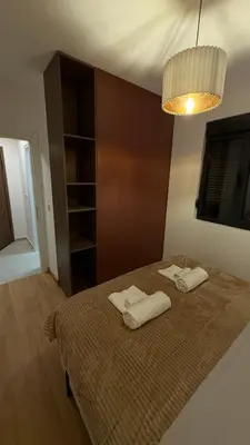 a bedroom with a bed with two towels on it at Becici Green Oasis Apartment - Nature & Comfort in Becici