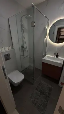 a bathroom with a shower and a toilet and a sink at Becici Green Oasis Apartment - Nature & Comfort in Becici