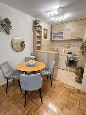 a kitchen and dining room with a table and chairs at Ilirija Budva Center Sea Style in Budva