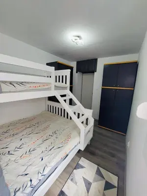 a bedroom with two bunk beds and a closet at Golden view apartman in Bar