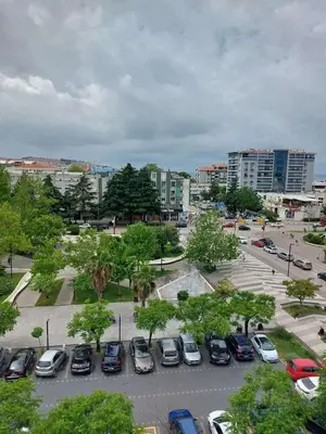 a parking lot with parked cars in a city at Golden view apartman in Bar