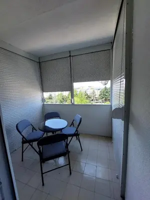 a room with a table and chairs and a window at Golden view apartman in Bar