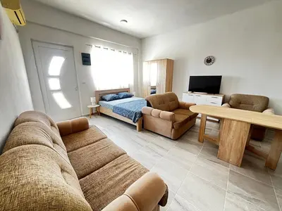 a living room with a couch and a bed at Vaidas place in Ulcinj
