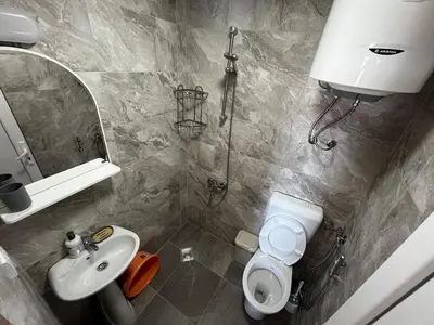 a bathroom with a sink and a toilet and a mirror at Vaidas place in Ulcinj