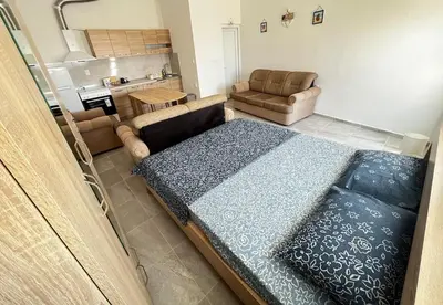 a living room with a large bed and a couch at Vaidas place in Ulcinj